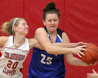 William D. Lewis The Vindicator  Columbiana's Alexis Cross(20)and past Lisbon's Maddie Liberati(25) go for the ball duringJan. 9, 2017 action at Columbiana.