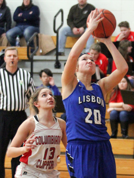 William D. Lewis The Vindicator  Lisbon's Autumn Oehlstrom(20) shoots past Columbiana' Mariah Rovnak(13)during jan. 9, 2017 action at Columbiana.