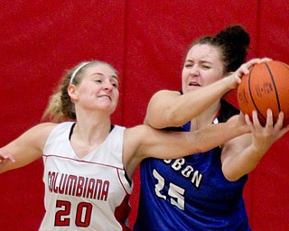William D. Lewis The Vindicator  Columbiana's Alexis Cross(20)and past Lisbon's Maddie Liberati(25) go for the ball duringJan. 9, 2017 action at Columbiana.