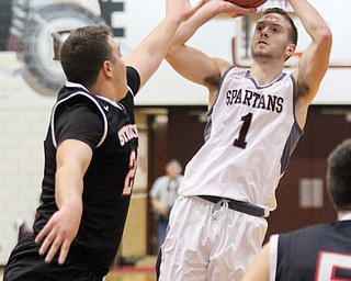 William D. Lewis The Vindicator Struthers Jaret Jacubec(24) tries to block Boardman's John Ryan(1) during Jan. 10 action at Boardman.