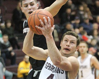 William D. Lewis The Vindicator Boardman's Mike Melewski(4) drives past Struthers Andrew Carbon (5)during Jan. 10 action at Boardman.