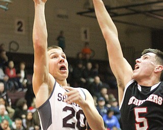 William D. Lewis The Vindicator Boardman's Coleman Stauffer(20) shoots over Struthers Andrew Carbon (5) during Jan. 10 action at Boardman.