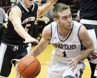 William D. Lewis The Vindicator  Bozrdman's John Ryan(1)  drives past Struthers Andrew Carbon (5)during Jan. 10 action at Boardman.