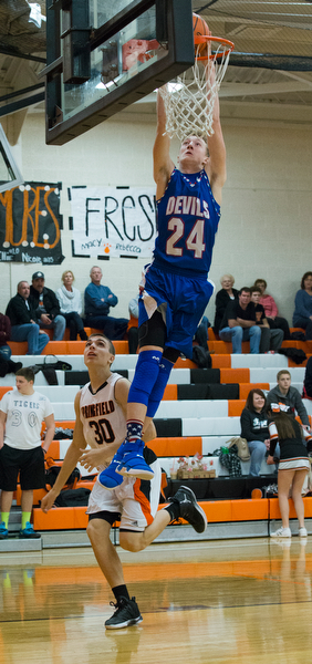 MICHAEL G TAYLOR | THE VINDICATOR- 01-10-17 -  Basketball -1st qtr, Reserve's #24 Kade Hilles slams the ball against Springfield's #30 Jake Ford. Western Reserve Blue Devils vs Springfield Tigers at New Middletown Springfield High School in New Middletown Springfield, OH.