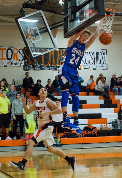 MICHAEL G TAYLOR | THE VINDICATOR- 01-10-17 -  Basketball -1st qtr, Reserve's #24 Kade Hilles slams the ball against Springfield's #30 Jake Ford. Western Reserve Blue Devils vs Springfield Tigers at New Middletown Springfield High School in New Middletown Springfield, OH