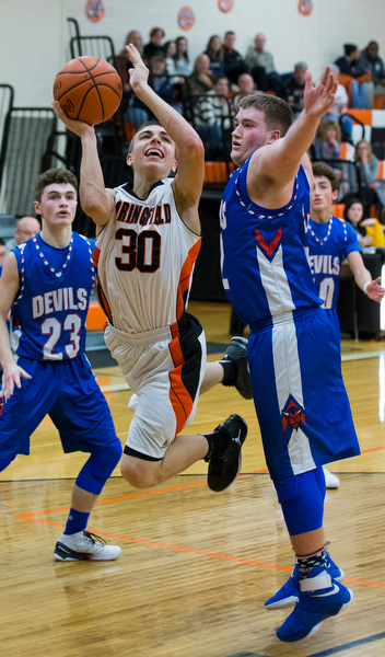 MICHAEL G TAYLOR | THE VINDICATOR- 01-10-17 -  Basketball -2nd qtr, Springfield's #30 Jake Ford drives to the hoop against Reserve's #32 Cody Hilles. Western Reserve Blue Devils vs Springfield Tigers at New Middletown Springfield High School in New Middletown Springfield, OH