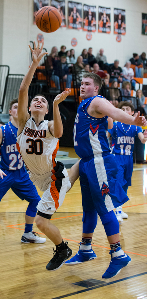 MICHAEL G TAYLOR | THE VINDICATOR- 01-10-17 -  Basketball -2nd qtr, Springfield's #30 Jake Ford drives to the hoop against Reserve's #32 Cody Hilles. Western Reserve Blue Devils vs Springfield Tigers at New Middletown Springfield High School in New Middletown Springfield, OH