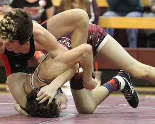 Canfield 120 pound wrestler McCoy Watkins(Black) wraps his leg around to maintain control of his headlock on Boardman 120 pound wrestler Derek Slipkovich(red) as Boardman High School Takes on Canfield High School at the Boardman High School Gymnasium  in Boardman on Wednesday, Jan. 11, 2017. ..(Nikos Frazier | The Vindicator)..