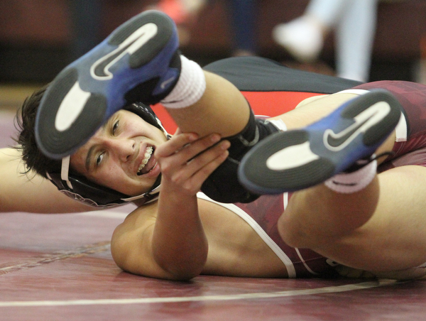 Boardman 126 pound wrestler Chandler Klinker(red) struggles against Canfield 126 pound wrestler Aiden Burscak(Black) as Boardman High School Takes on Canfield High School at the Boardman High School Gymnasium  in Boardman on Wednesday, Jan. 11, 2017. ..(Nikos Frazier | The Vindicator)..