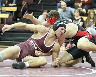 Canfield 170 pound wrestler Nick Crawford(Black) spins .Boardman 170 pound wrestler Michael O'Horo(red) around for a better hold as Boardman High School Takes on Canfield High School at the Boardman High School Gymnasium  in Boardman on Wednesday, Jan. 11, 2017. ..(Nikos Frazier | The Vindicator)..
