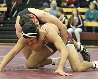 Canfield 170 pound wrestler Nick Crawford(Black) locks .Boardman 170 pound wrestler Michael O'Horo(red) in a headlock as Boardman High School Takes on Canfield High School at the Boardman High School Gymnasium  in Boardman on Wednesday, Jan. 11, 2017. ..(Nikos Frazier | The Vindicator)..