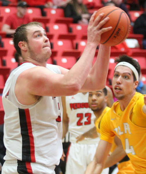 William D. Lewis The Vindicator YSU's Jorden Kaufman(32) shoots past Valpo's Jaume Sorolla (14) during Jan 12 , 2017 action at YSU.