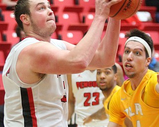 William D. Lewis The Vindicator YSU's Jorden Kaufman(32) shoots past Valpo's Jaume Sorolla (14) during Jan 12 , 2017 action at YSU.