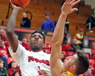 William D. Lewis The Vindicator YSU's Braun Hartfield(1) shoots past Valpo's Alec Peters(25) during Jan 12 , 2017 action at YSU.