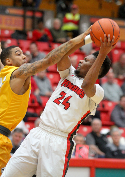 William D. Lewis The Vindicator YSU's Cameron Morse(24) shoots past Valpos Tevonn Walker (2)during Jan 12 , 2017 action at YSU.