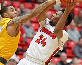 William D. Lewis The Vindicator YSU's Cameron Morse(24) shoots past Valpos Tevonn Walker (2)during Jan 12 , 2017 action at YSU.