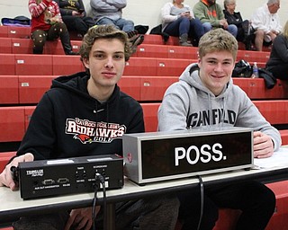 Neighbors | Abby Slanker.Canfield High School basketball players Zach Tinkey (left) and Tyler Dobrindt worked the scorers table at the third annual Canfield Cardinal Classic boys basketball tournament on Dec. 11.