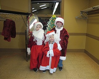Neighbors | Alexis Bartolomucci.Michael, Nicholas and Zachary Scharsten dressed up like Santa Claus during the Supper with Santa event at Boardman Park on Dec. 8.