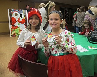 Neighbors | Alexis Bartolomucci.Alyssa and Elizabeth showed off their Santa Claus ornaments they made during the Supper with Santa event at Boardman Park on Dec. 8.
