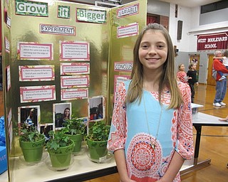 Neighbors | Alexis Bartolomucci.Kaitlyn Costantin did her science experiment on what makes plants grow the largest for the fourth-grade science fair on Dec. 8 at West Boulevard Elementary.