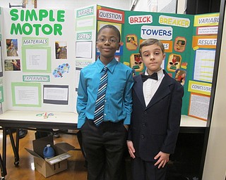 Neighbors | Alexis Bartolomucci.Deshaun Holmes and Dominic Cheff stood in front of their science experiments during the fourth-grade science fair at West Boulevard on Dec. 8.