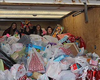 Neighbors | Abby Slanker.Canfield High School students, left to right, Clare Crescimanno, Sydney Stewart, Melissa Dahman and Kate Hartshorn, surveyed the 325 items donated to the Salvation Army Angel Tag Drive with donations coming from all Student Council members, CHS staff, Interact Club and Canfield Rotary on Dec. 7.