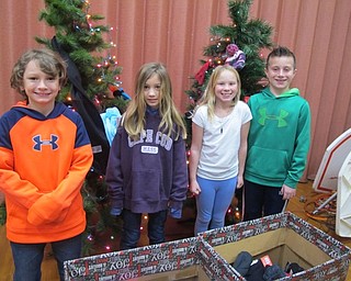 Neighbors | Alexis Bartolomucci.Third-grade students stood in front of the Giving Tree that Dobbins Elementary is having to collect donations. Pictured are, form left, Connor, Kate, Natalie and Dylan.