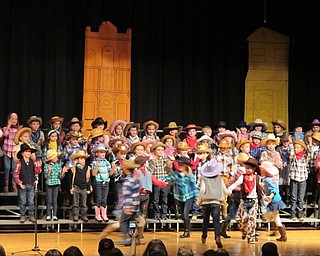 Neighbors | Alexis Bartolomucci.Some of the first-grade students danced on the stage as the other students sang a song during the Western style musical performance on Dec. 20 at Poland Seminary High School.