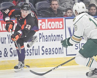 William D Lewis/The Vindicator  Phantoms Steve ruggiero(28) shoots past Musketeers Connor Mayer(18) during Jan. 13, 2017 action at Covelli.