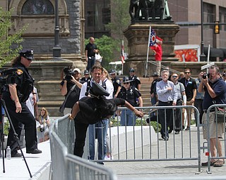 Nikos Frazier | The Vindicator..Kathy Coleman falls over a police barricade in Cleveland's Public Square while trying to evade police. Coleman was taken into custody by the Cleveland Police Department for an outstanding Felony Warrant according to an official at the Department.