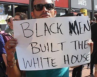 Nikos Frazier | The Vindicator..A protestor holds a "Black men built the White House" during a protest on the second day of the Republican National Convention.