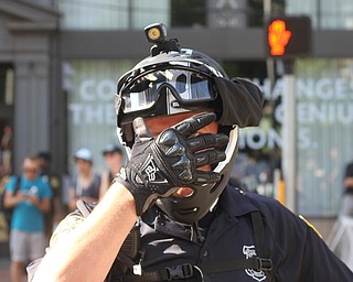 Nikos Frazier | The Vindicator..A Cleveland Police Department shields his face from photographers.