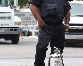 Nikos Frazier | The Vindicator..A Cleveland Firefighter stands on W Lakeside Ave outside of the Justice Center on the fourth and final day of the Republican National Convention.