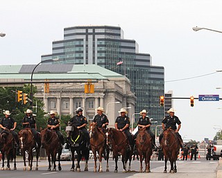 Nikos Frazier | The Vindicator..Fort Worth mounted patrol and a Cleveland Police mounted patrol(center) watch a gathering outside the Justice Center on W. Lakeside Ave on the fourth and final day of the Republican National Convention.