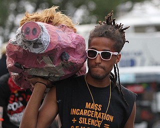 Nikos Frazier | The Vindicator..A protestor carries a papermache pig on the fourth and final day of the Republican National Convention.