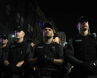 Nikos Frazier | The Vindicator..Ohio State Troopers watch protestors during the fourth and final day of the Republican National Convention.