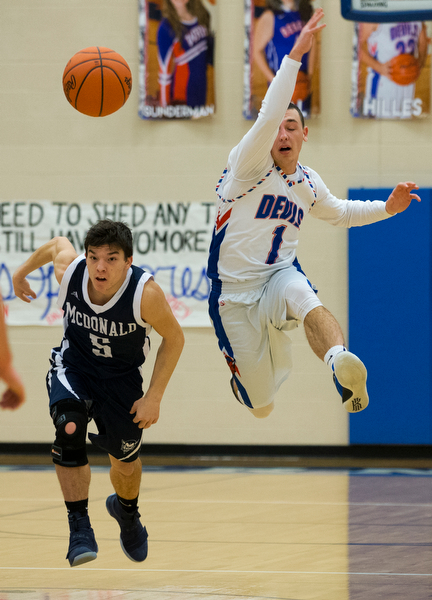 MICHAEL G TAYLOR | THE VINDICATOR- 01-13-17 -  Basketball -1st qtr, Reserve's #1 Wyatt Larimerhas the ball knocked out of hands by Mcdonald's #5 Josh Celli. Mcdonald Blue Devils vs Western Reserve Blue Devils Western Reserve Springfield High School in Berlin Center Western Reserve, OH.