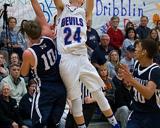 MICHAEL G TAYLOR | THE VINDICATOR- 01-13-17 -  Basketball -1st qtr, Reserve's #24 Kade Hilles nails a buzzer beating 3pt. shot over Mcdonald's #10 Evan Magil. Mcdonald Blue Devils vs Western Reserve Blue Devils Western Reserve Springfield High School in Berlin Center Western Reserve, OH