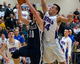 MICHAEL G TAYLOR | THE VINDICATOR- 01-13-17 -  Basketball -2nd qtr, Mcdonald's #10 Evan Magil drives the ball against Reserve's #34 Jack Cappabianca. Mcdonald Blue Devils vs Western Reserve Blue Devils Western Reserve Springfield High School in Berlin Center Western Reserve, OH