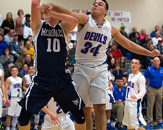 MICHAEL G TAYLOR | THE VINDICATOR- 01-13-17 -  Basketball -2nd qtr, Mcdonald's #10 Evan Magil drives the ball against Reserve's #34 Jack Cappabianca. Mcdonald Blue Devils vs Western Reserve Blue Devils Western Reserve Springfield High School in Berlin Center Western Reserve, OH