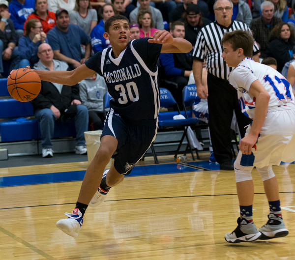 MICHAEL G TAYLOR | THE VINDICATOR- 01-13-17 -  Basketball -2nd qtr, Mcdonald's #30 Braedon Poole drives to the hoop against Reserve's #12 Riley Miller. Mcdonald Blue Devils vs Western Reserve Blue Devils Western Reserve Springfield High School in Berlin Center Western Reserve, OH