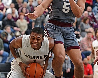 WARREN, OHIO - JANUARY 13, 2017: Derek Culver #1 of Harding goes up to the basket while Travis Koontz #5 of Boardman comes down on him during the first half of their game Friday night at Warren Harding High School. DAVID DERMER | THE VINDICATOR
