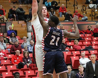 Youngstown State senior center Jorden Kaufman(32) attempts to put up two while being guarded by University of Illinois at Chicago junior forward Tai Odiase(21) during the first half as the Youngstown State Penguins take on the University of Illinois at Chicago Flames at the Beeghly Center in Youngstown on Saturday, Jan. 14, 2017. UIC won, 92-89 in Overtime...(Nikos Frazier | The Vindicator)..