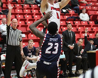 Youngstown State senior forward Matt Dolan(0) puts up two against University of Illinois at Chicago freshman guard Marcus Ottey(23) during the first half as the Youngstown State Penguins take on the University of Illinois at Chicago Flames at the Beeghly Center in Youngstown on Saturday, Jan. 14, 2017. UIC won, 92-89 in Overtime...(Nikos Frazier | The Vindicator)..