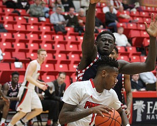 Youngstown State freshman guard Braun Hartfield(1) is blocked for a shot by University of Illinois at Chicago junior forward Clint Robinson(32) during the first half as the Youngstown State Penguins take on the University of Illinois at Chicago Flames at the Beeghly Center in Youngstown on Saturday, Jan. 14, 2017. UIC won, 92-89 in Overtime...(Nikos Frazier | The Vindicator)..
