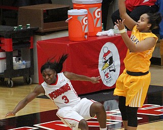Youngstown State junior guard Indiya Benjamin(3) falls after blocking Valparaiso freshman guard Maya Meredith(0) during the third quarter as the Youngstown State Penguins take on the Valparaiso Crusaders at the Beeghly Center in Youngstown on Saturday, Jan. 14, 2017. Youngstown State won, 76-70...(Nikos Frazier | The Vindicator)..