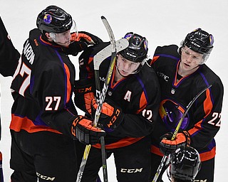 YOUNGSTOWN, OHIO - JANUARY 16, 2017: Austin Pooley #12 of the Phantoms, center, celebrates with teammates Michael Karow #27 and Brandon Estes #22 after scoring a empty net goal during the third period of their game Monday afternoon at the Covelli Centre. The Phantoms won 4-1. DAVID DERMER | THE VINDICATOR