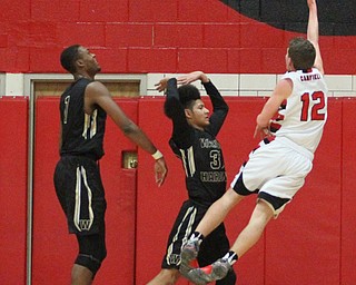 Canfield junior guard Ethan Kalina(12) attempts a hook shot during the first quarter as Warren G. Harding High School takes on Canfield High School at the Canfield High School Gymnasium in Canfield on Tuesday, Jan. 17, 2017. Harding won, 80-62...(Nikos Frazier | The Vindicator)..