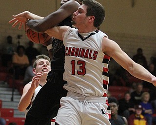 Harding senior Derek Culver(1) flies towards the net while Canfield senior forward Jared Clark(13) tries to swipe the ball from him during the second quarter as Warren G. Harding High School takes on Canfield High School at the Canfield High School Gymnasium in Canfield on Tuesday, Jan. 17, 2017. Harding won, 80-62...(Nikos Frazier | The Vindicator)..