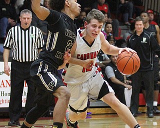 Canfield junior guard Ethan Kalina(12) tries to evade Harding junior Chris Hughes(23) during the third quarter as Warren G. Harding High School takes on Canfield High School at the Canfield High School Gymnasium in Canfield on Tuesday, Jan. 17, 2017. Harding won, 80-62...(Nikos Frazier | The Vindicator)..